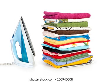 Pile Of Colorful Clothes And Electric Iron Isolated On White