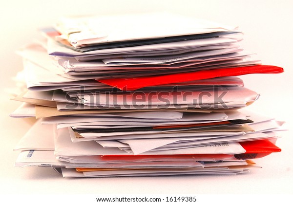 A pile of colorful letters and junk mail on a\
table isolated on white\
background