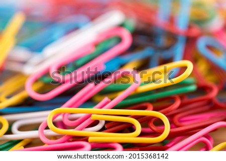 Pile of colorful paper clips macro abstract background