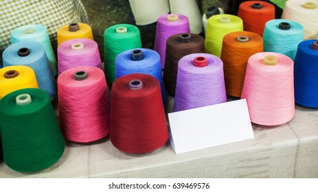 A pile of colorful spools of thread - Closeup Detail