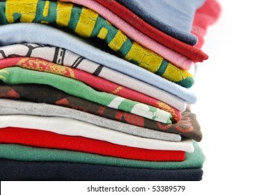 pile of colorful t-shirts isolated on white background