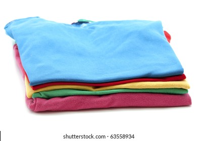 pile of colorful T-shirts isolated on white