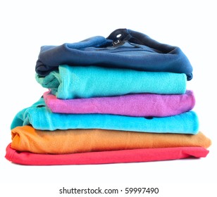 Pile of coloured clothes from the laundry - isolated on white