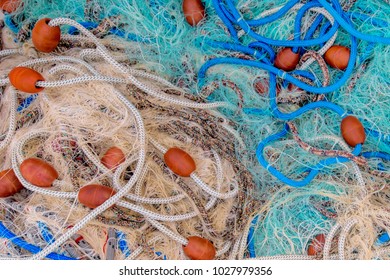 Pile Of Commercial Fishing Net With Cords And Floats As Abstract Background, Selective Focus