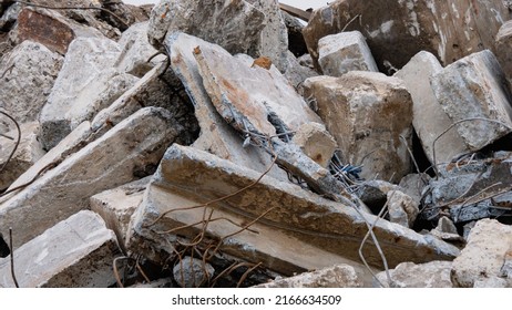 A pile of concrete debris from a building. Destroyed cement building. Concrete fragments of the building close-up. Explosion or demolition of buildings. Construction debris