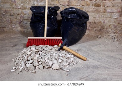 Pile Of Construction Rubble, Garbage Bags And Broom