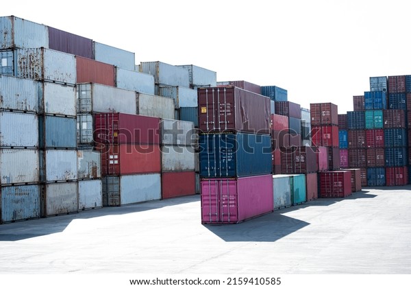 a pile of container in freight yard against a\
blue sky, transport\
background