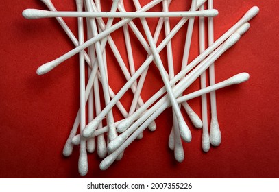 Pile Of Cotton Buds On Red Background