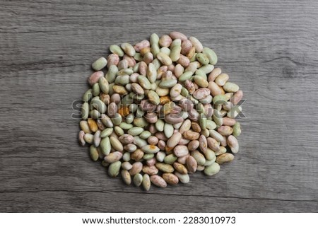 Pile of The Cranberry Bean (Phaseolus vulgaris) on the wooden background