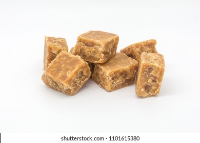 A Pile Of Crumbly Fudge Against A White Background