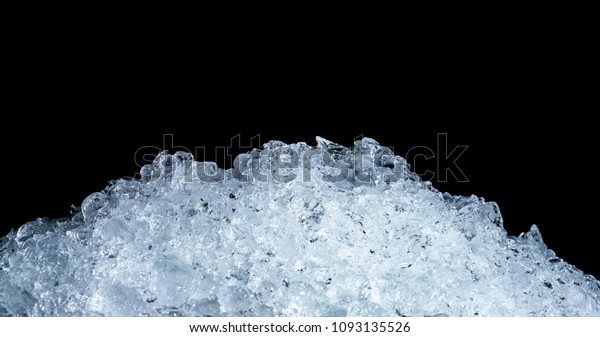 Pile of crushed ice\
cubes on dark background with copy space. Crushed ice cubes\
foreground for beverages.