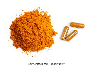 Pile of curcumin powder and Curcuma capsules isolated on white background. Health benefits and antioxidant food concept. Top view. Flat lay. 