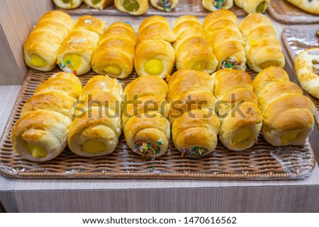 Pile of custard bread bun for sale at pastry shop