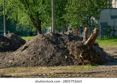 Pile debris garbage.Remove earthen ground before laying asphalt