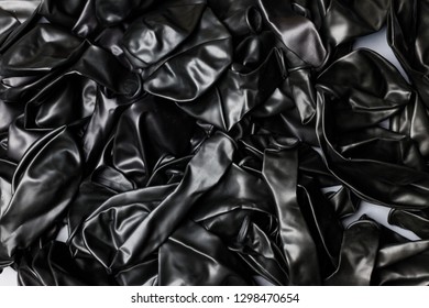 Pile Of Deflated Black Balloons On A White Background. Clean Pure Baloon Template. Logo, Texture, Pattern Presentation Plain Aerostat Design Element.