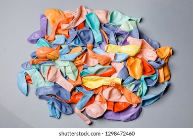 Pile Of Deflated Color Pastel Balloons On A White Background. Clean Pure Baloon Template. Logo, Texture, Pattern Presentation Plain Aerostat Design Element.