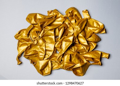 Pile Of Deflated Gold Balloons On A White Background. Clean Pure Baloon Template. Logo, Texture, Pattern Presentation Plain Aerostat Design Element.