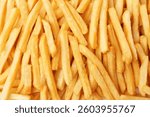 Pile of delicious French fries as background, top view