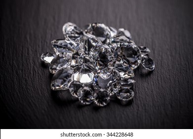 Pile Of Diamonds On Dark Metal Surface