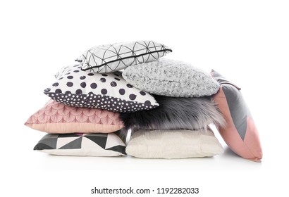 Pile of different colorful pillows on white background