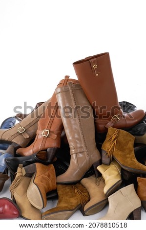 Pile of different female leather boots background


