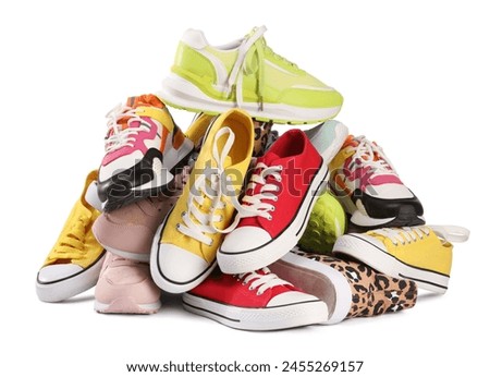 Pile of different female sneakers isolated on white