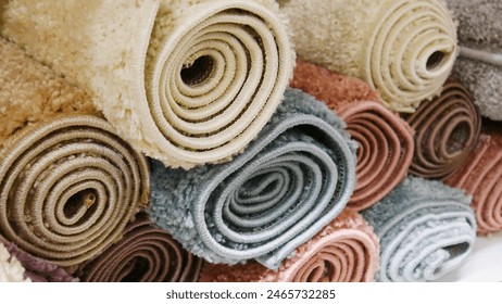A pile of different soft colored carpets close-up