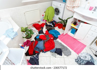 Pile Of Dirty Clothes Ready For The Wash In Home Bathroom