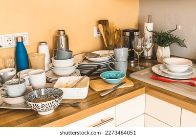Pile of dirty dishes in the kitchen - Compulsive Hoarding Syndrome - Shutterstock ID 2273484051