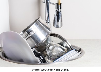 Pile Of Dirty Dishes In The Sink