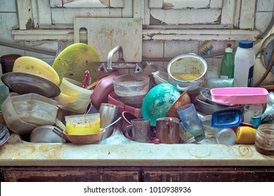 Pile Of Dirty Utensils In A Kitchen Washbasin