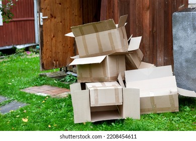 a pile of discarded empty cardboard boxes outside a house, outdoor shot - Shutterstock ID 2208454611