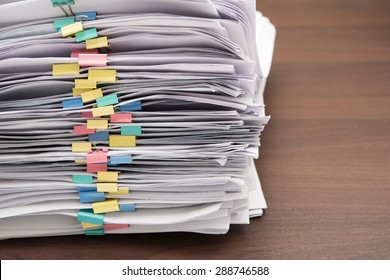 Pile of documents with colorful clips on desk stack up - Powered by Shutterstock