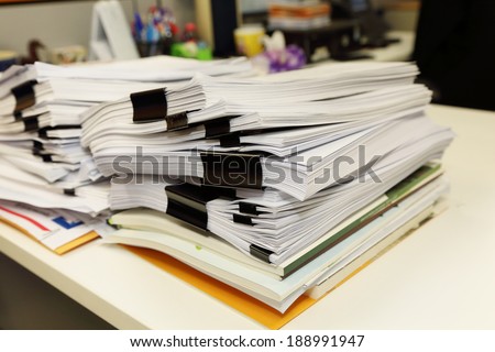 pile of documents on the office desk