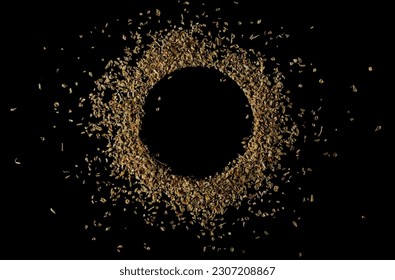 Pile of dried oregano leaves in shape circle isolated on black, top view, clipping path