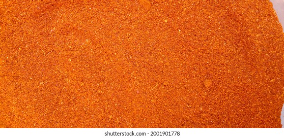 Pile Of Dried Red Cayenne Or Hot Pepper (Capsicum Annuum) After Grinding. Cayenne Pepper Powder In Pot. Pile Of Red Paprika Powder Texture Background. Crushed Red Chili