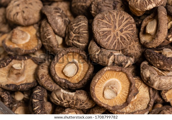 Pile of dried shiitake\
mushrooms for sale in market. The shiitake is an edible mushroom\
native to East Asia, which is cultivated and consumed in many Asian\
countries.