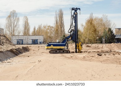Pile driver at a construction site. A pile machine for deep foundation installation
