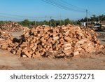 Pile of dry firewood in the form of chips ready for sale to burn in a fireplace on cold days