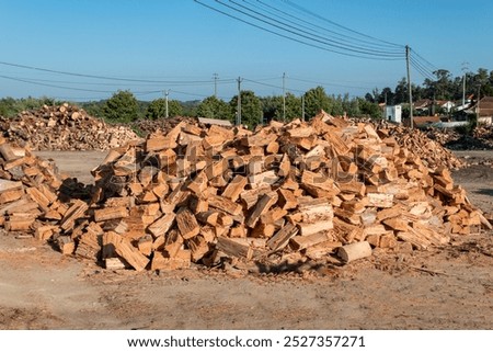 Pile of dry firewood in the form of chips ready for sale to burn in a fireplace on cold days