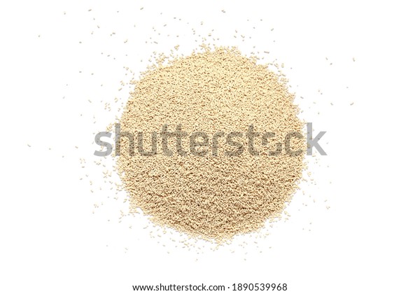 Pile of dry yeast isolated on white background,\
top view. Active dry yeast on a white background, top view. Dry\
yeast granules isolated on white background. Dry yeast is used in\
baked goods.