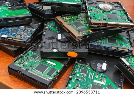 A pile of dusty broken and obsolete hard drives for disposal and recycling. Electronic data warehouse