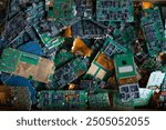 pile of electronic waste on factory floor is circuit board of mobile phone waiting to be processed extract gold to separate precious metal from electronic waste. extracting precious metal from e-waste