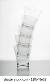 Pile Of Empty Glasses Over White Background