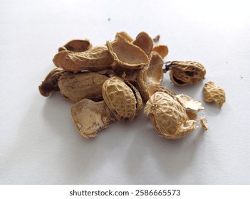 A pile of empty peanut shell isolated on white background. Snack time or food waste campaign.