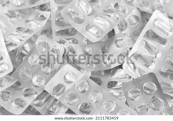 Pile of empty pill blisters. Treatment concept.\
Many blank blisters from pills as a background. Shallow depth of\
field. Selective focus.
