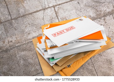 Pile Of Envelopes With Overdue Utility Bills On The Floor