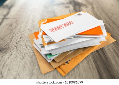 Pile of envelopes with overdue utility bills on the desk