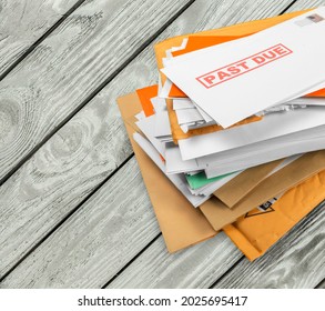 Pile Of Envelopes With Overdue Utility Bills On The Desk