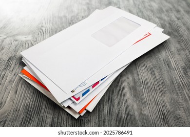 Pile Of Envelopes With Overdue Utility Bills On The Desk